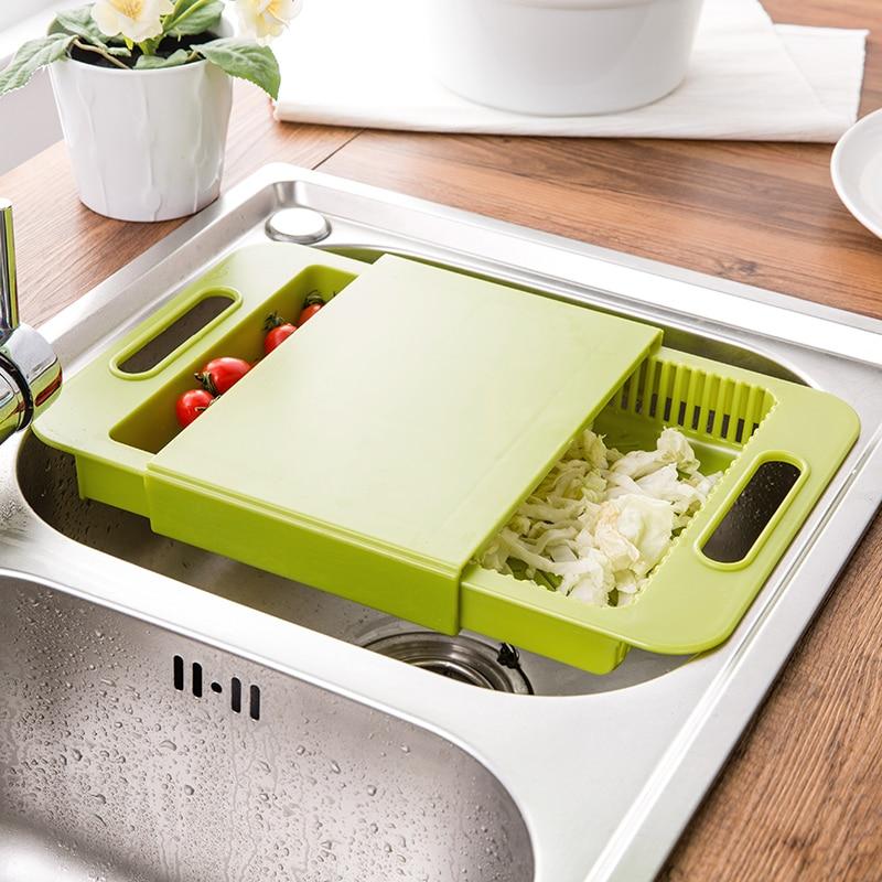 Over-the-sink cutting board with removable drain basket and prep tray